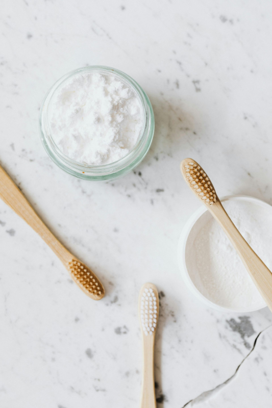 Toothbrushes and toothpaste on a marble bathroom counter
