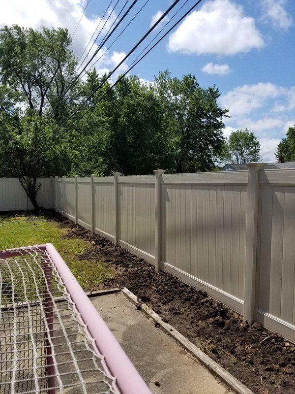 Tan vinyl privacy fence