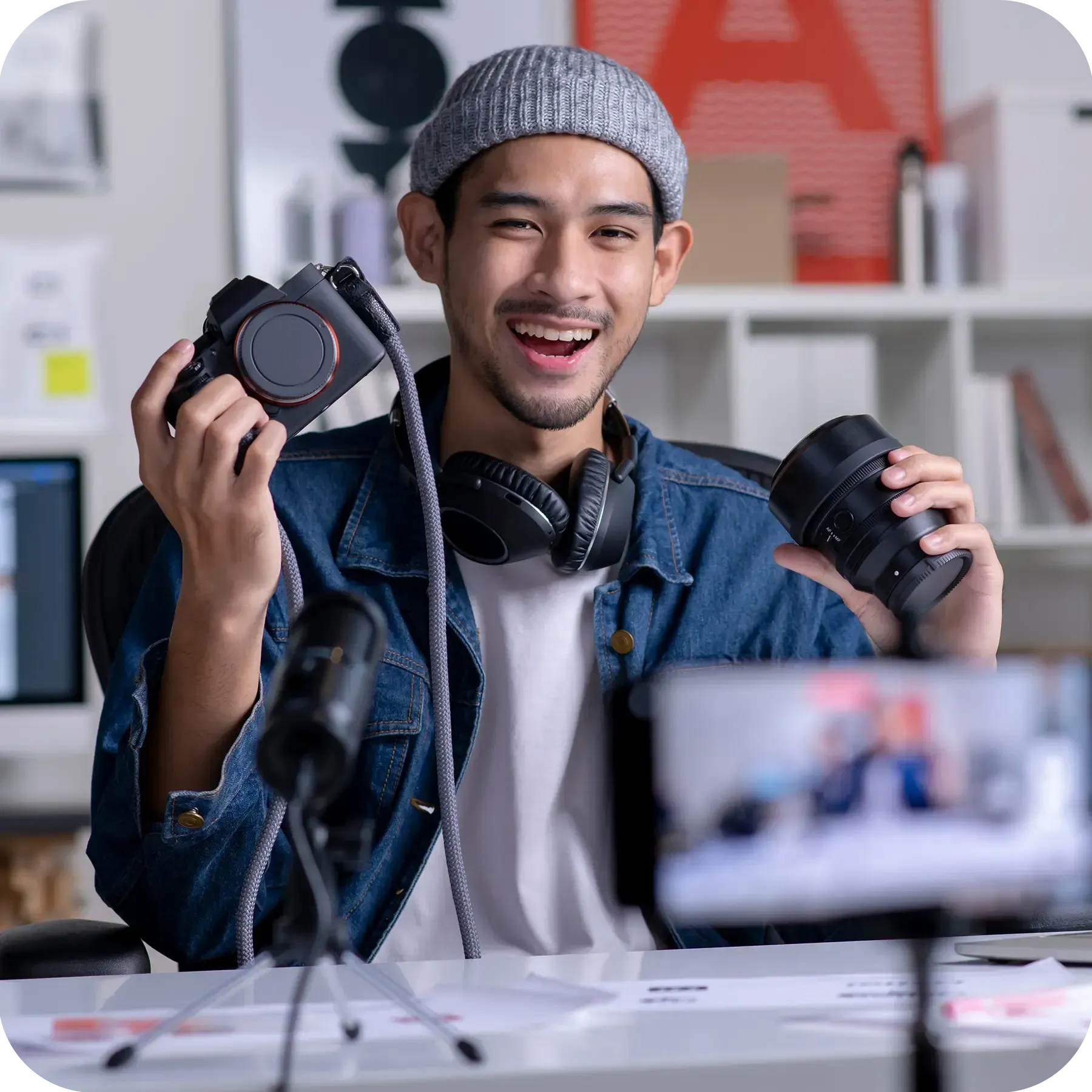 Young Asian man filming teaching camera tutorial while looking at camera