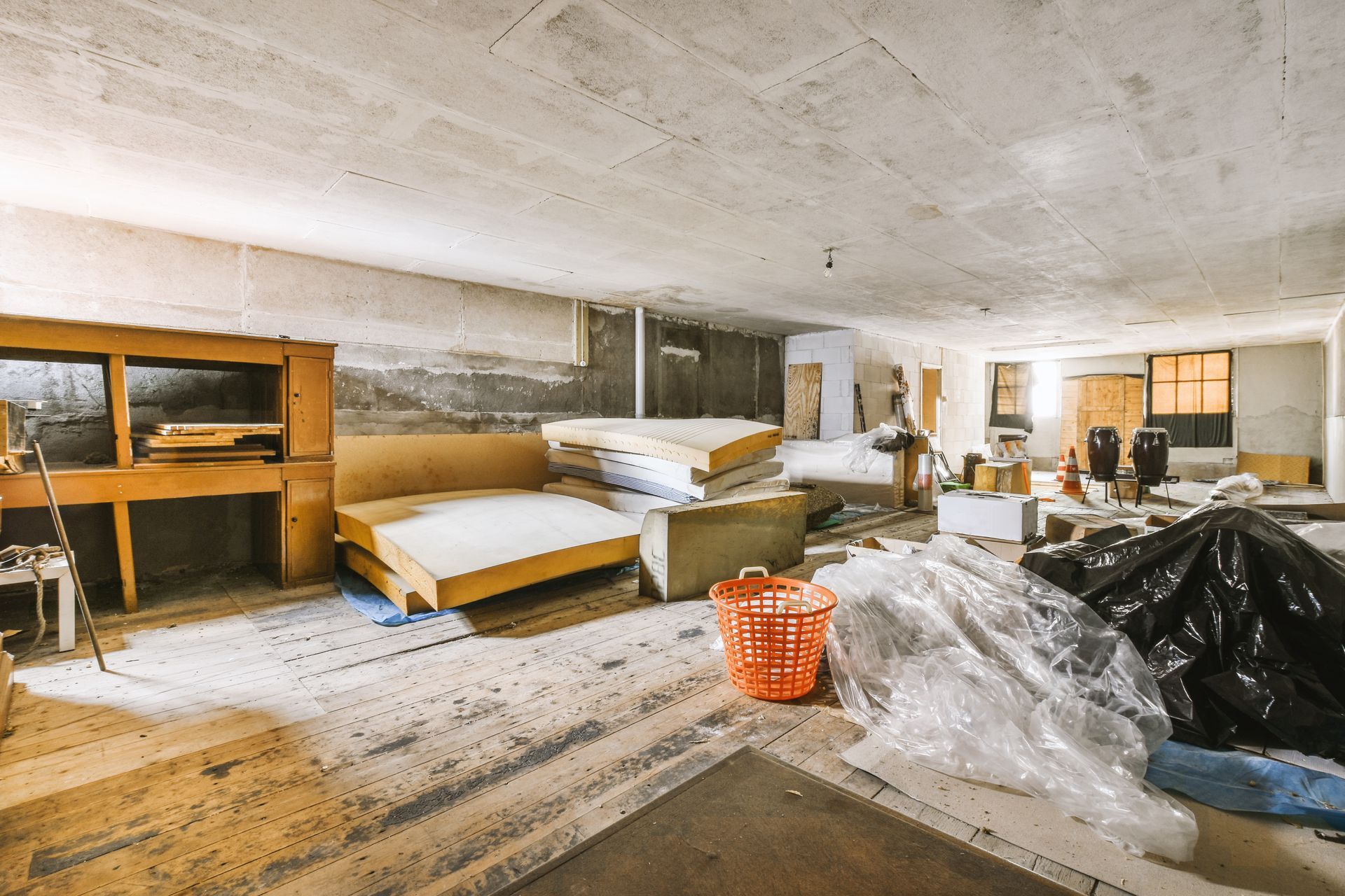 A large room with a lot of furniture in it is being remodeled.
