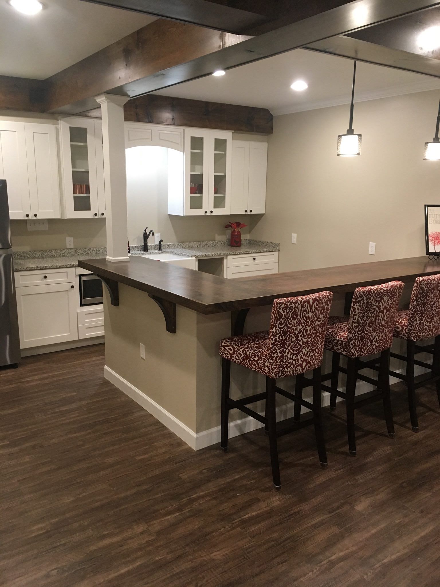 A kitchen with a table and chairs and a refrigerator