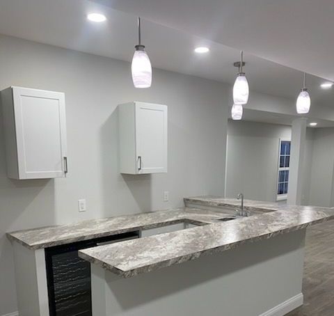 A large kitchen with a large island and lots of windows.