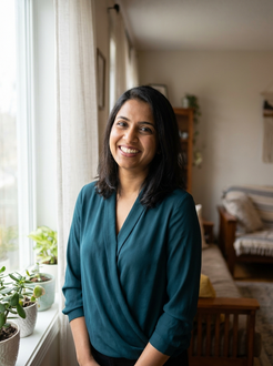 South Asian woman smiling confidently, representing anxiety therapy support in Etobicoke