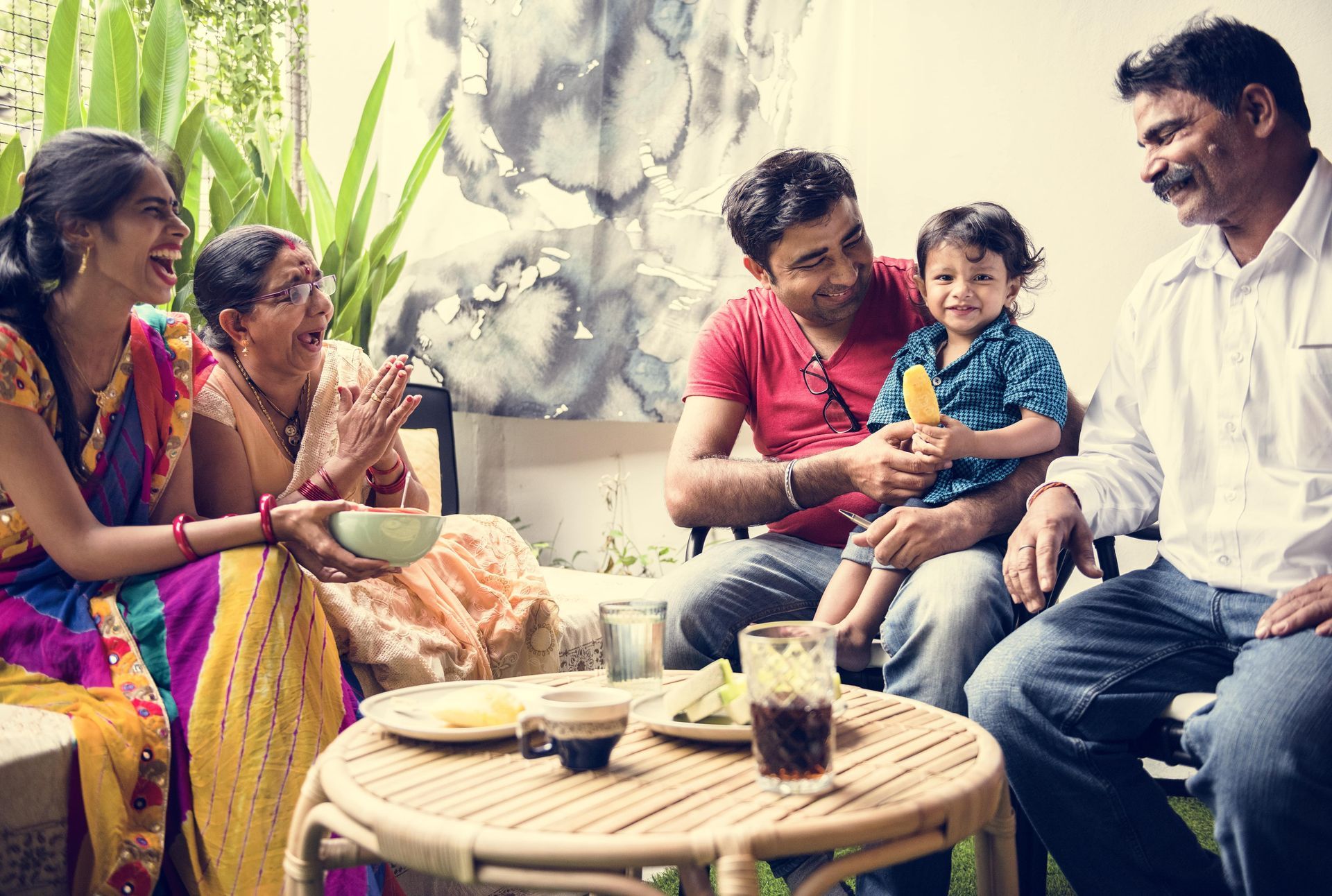A group of people are sitting around a table eating food.