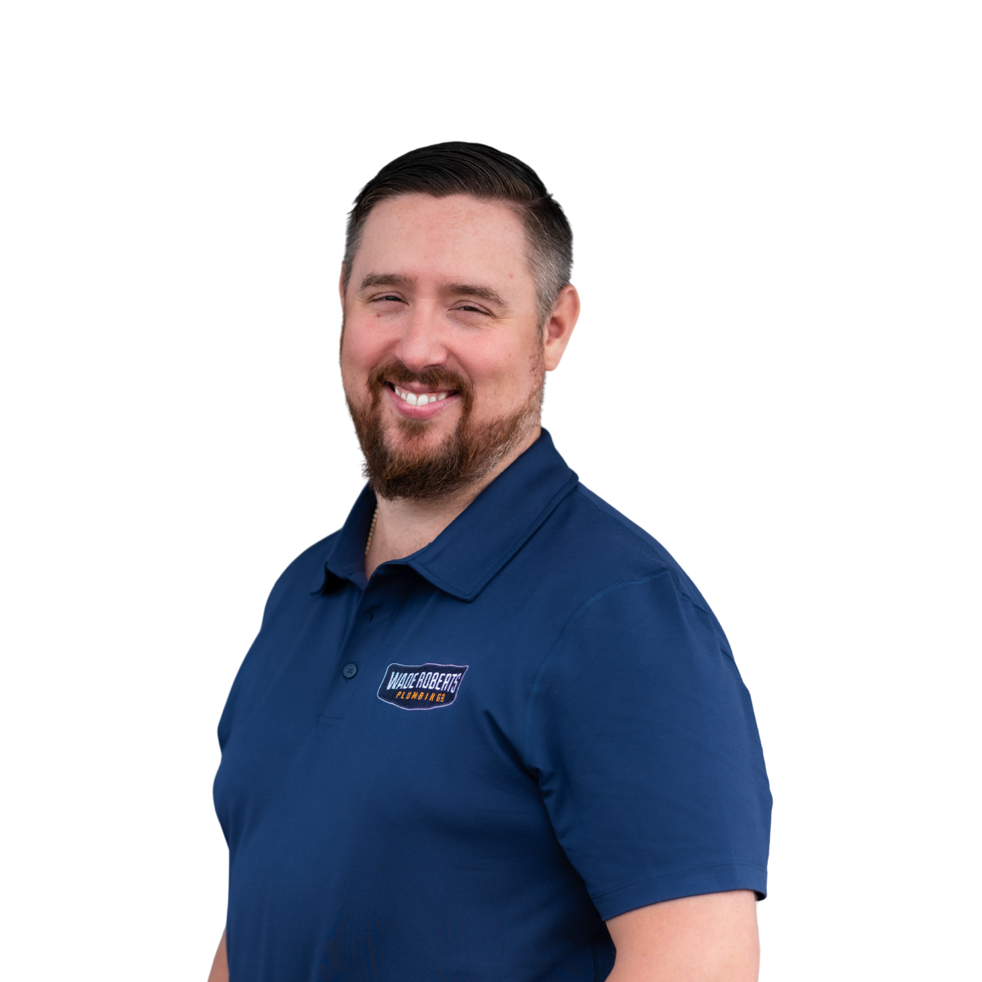 A man with a beard is wearing a black shirt and smiling