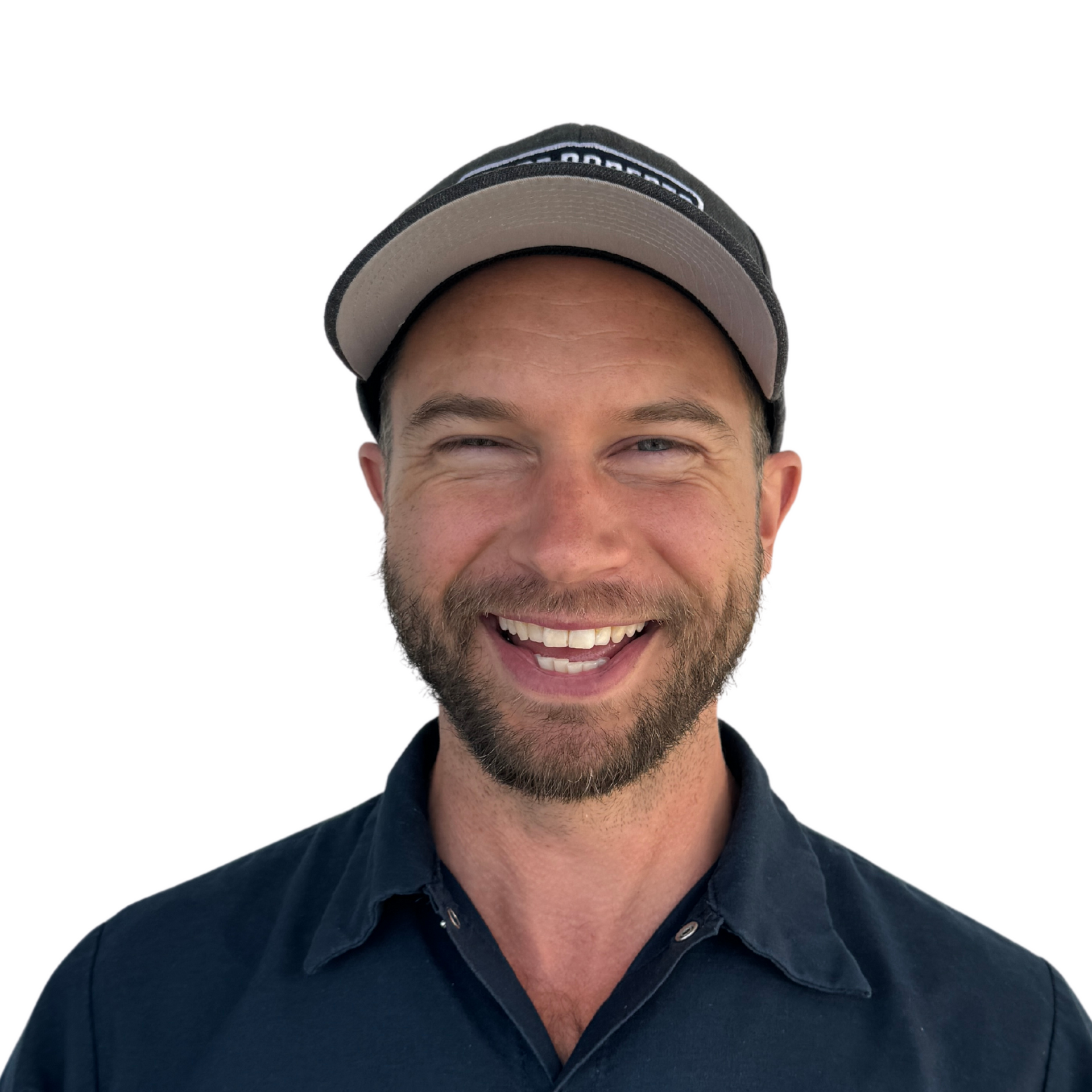 A man with a beard wearing a hat and smiling