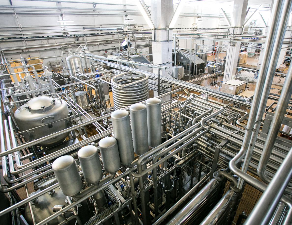 A factory filled with lots of pipes and machinery.