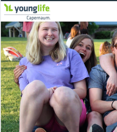 Young Life Capernaum logo above smiling youths sitting outdoors on grass