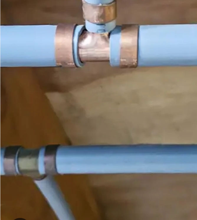 A close up of a row of underfloor heating pipes.