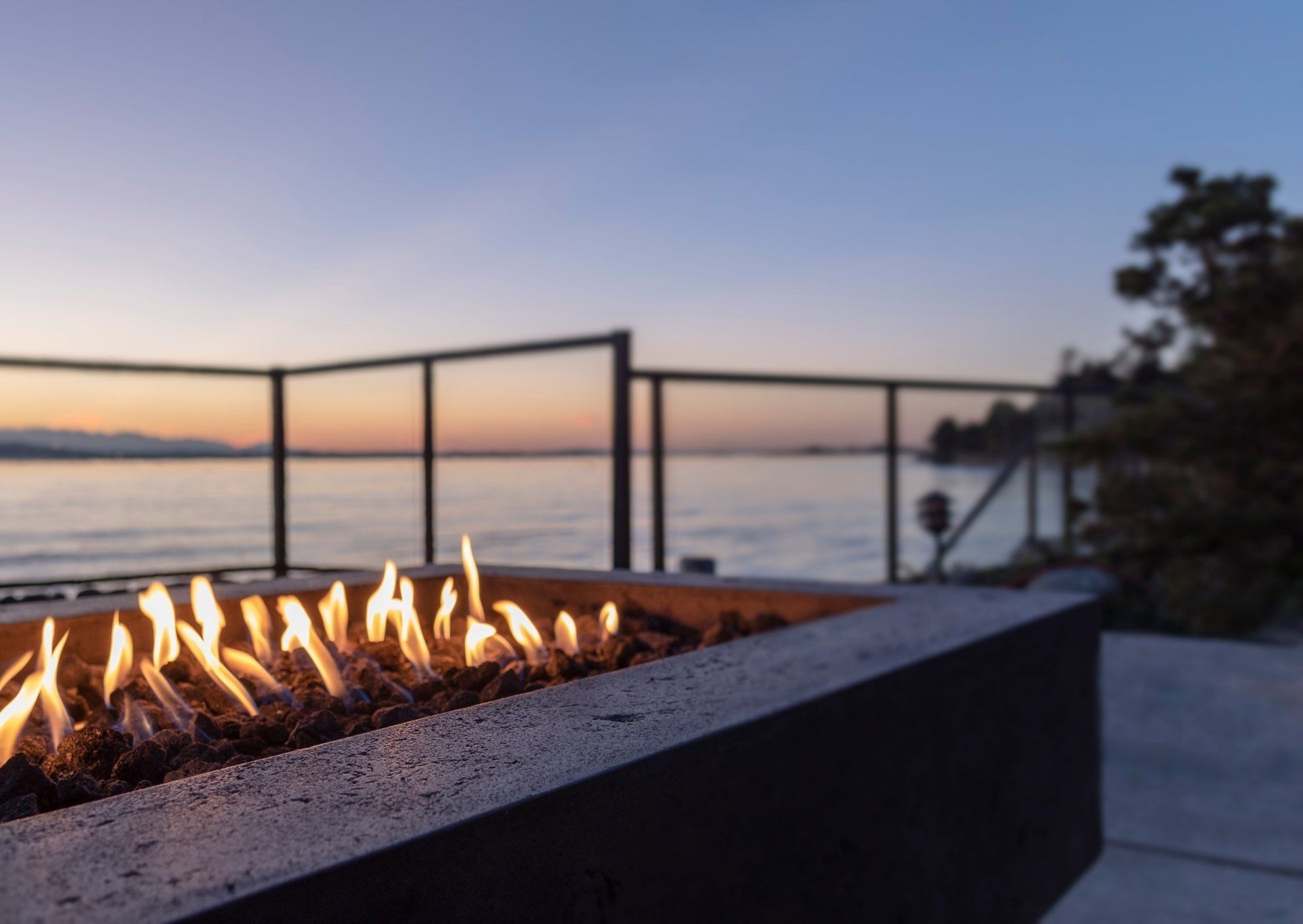 A fire pit on a balcony overlooking the ocean