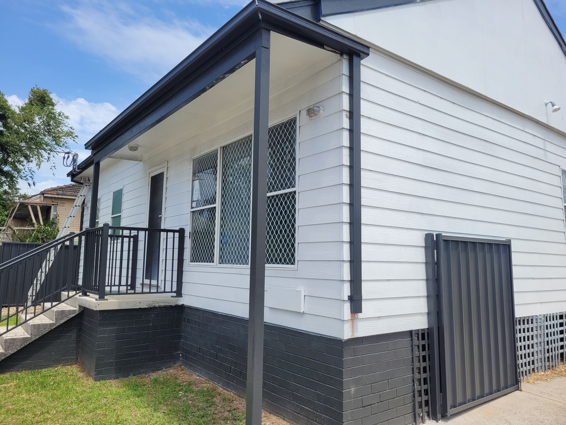A white house with dark gutters — GT Metal Roofing Solutions in Illawarra, NSW 