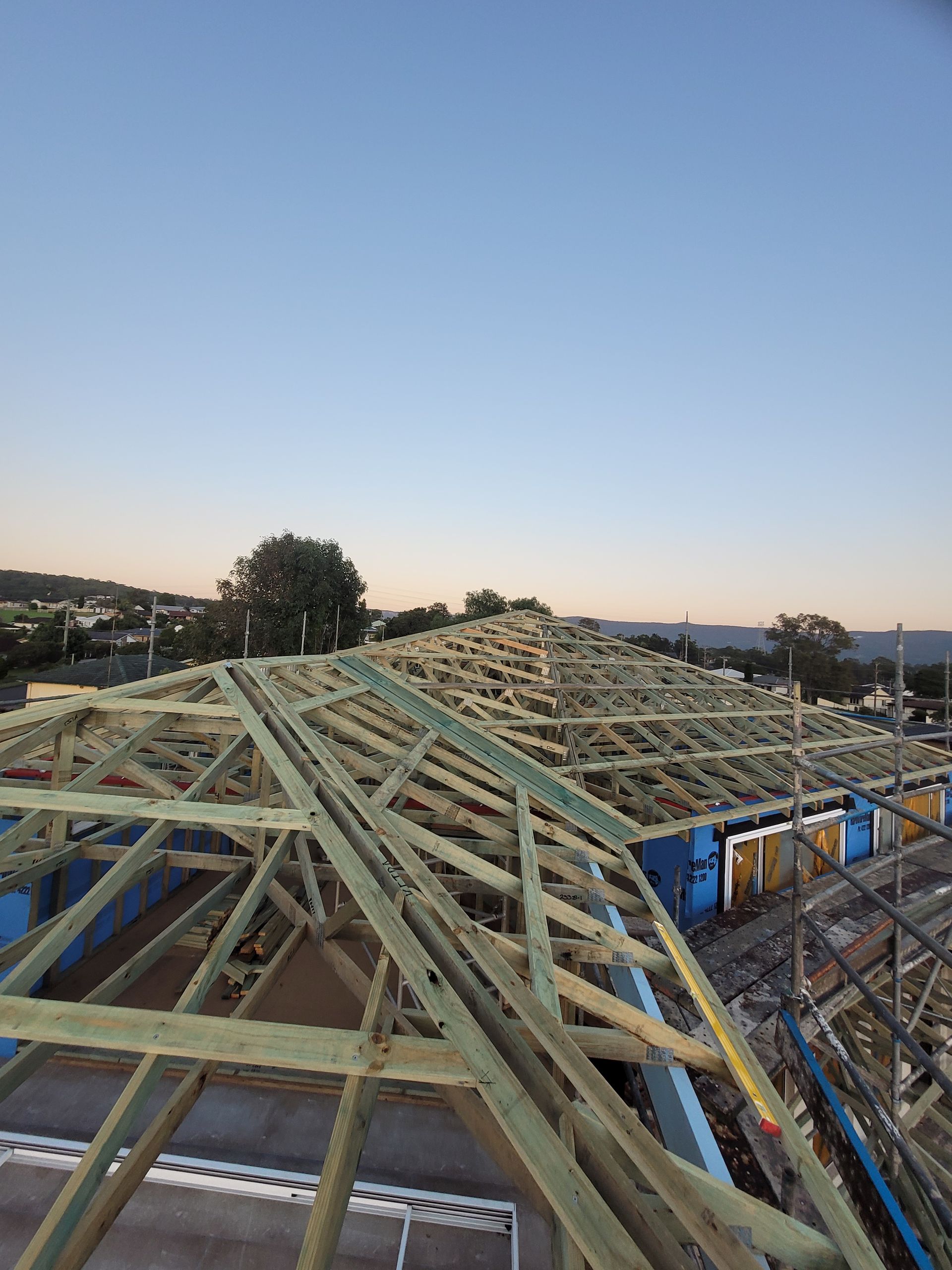 A Large Wooden Structure is Being Built on Top of a Building — GT Metal Roofing Solutions in Corrimal, NSW 