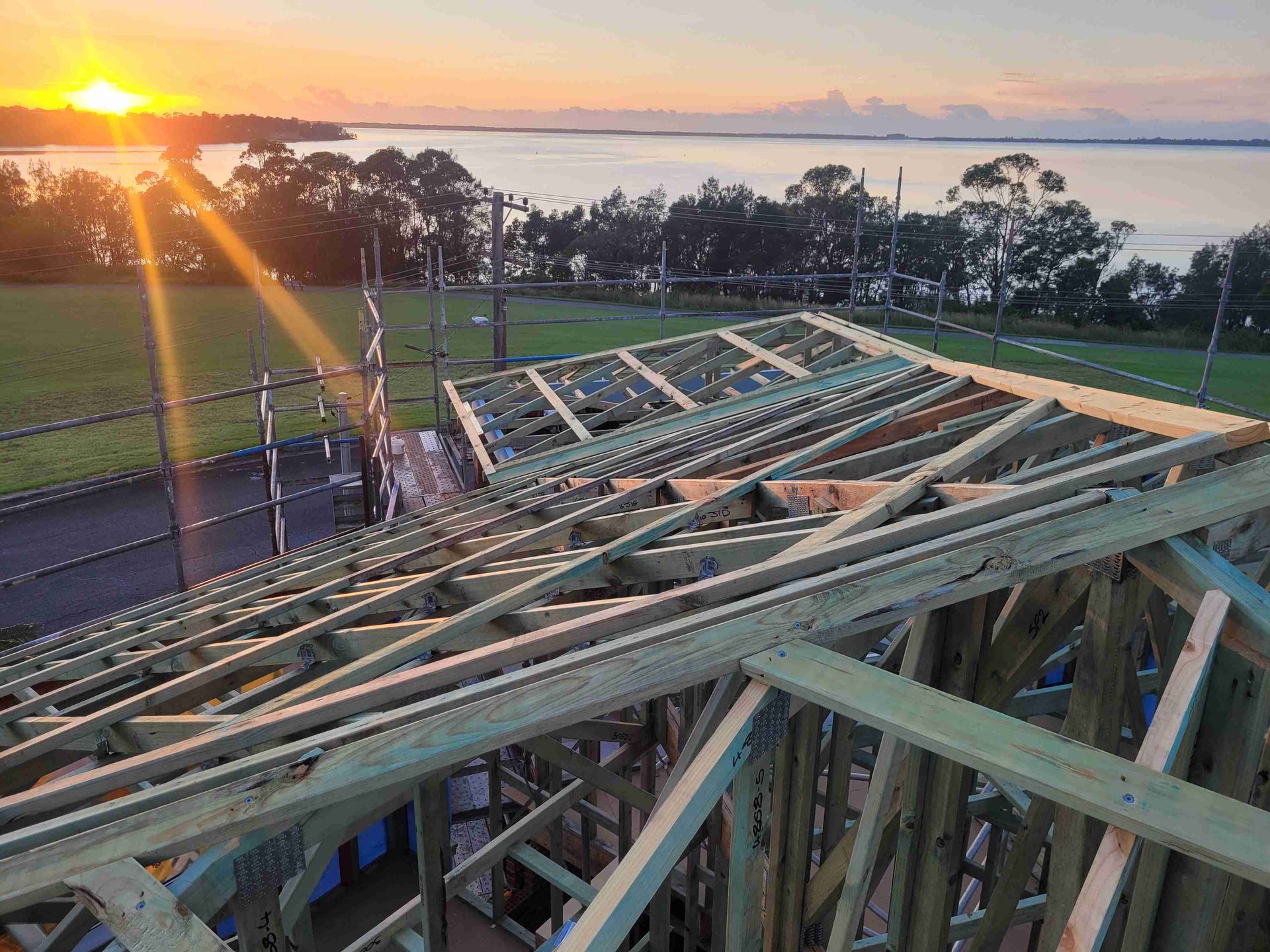 Roof being built with sunset behind — GT Metal Roofing Solutions in Shoalhaven, NSW