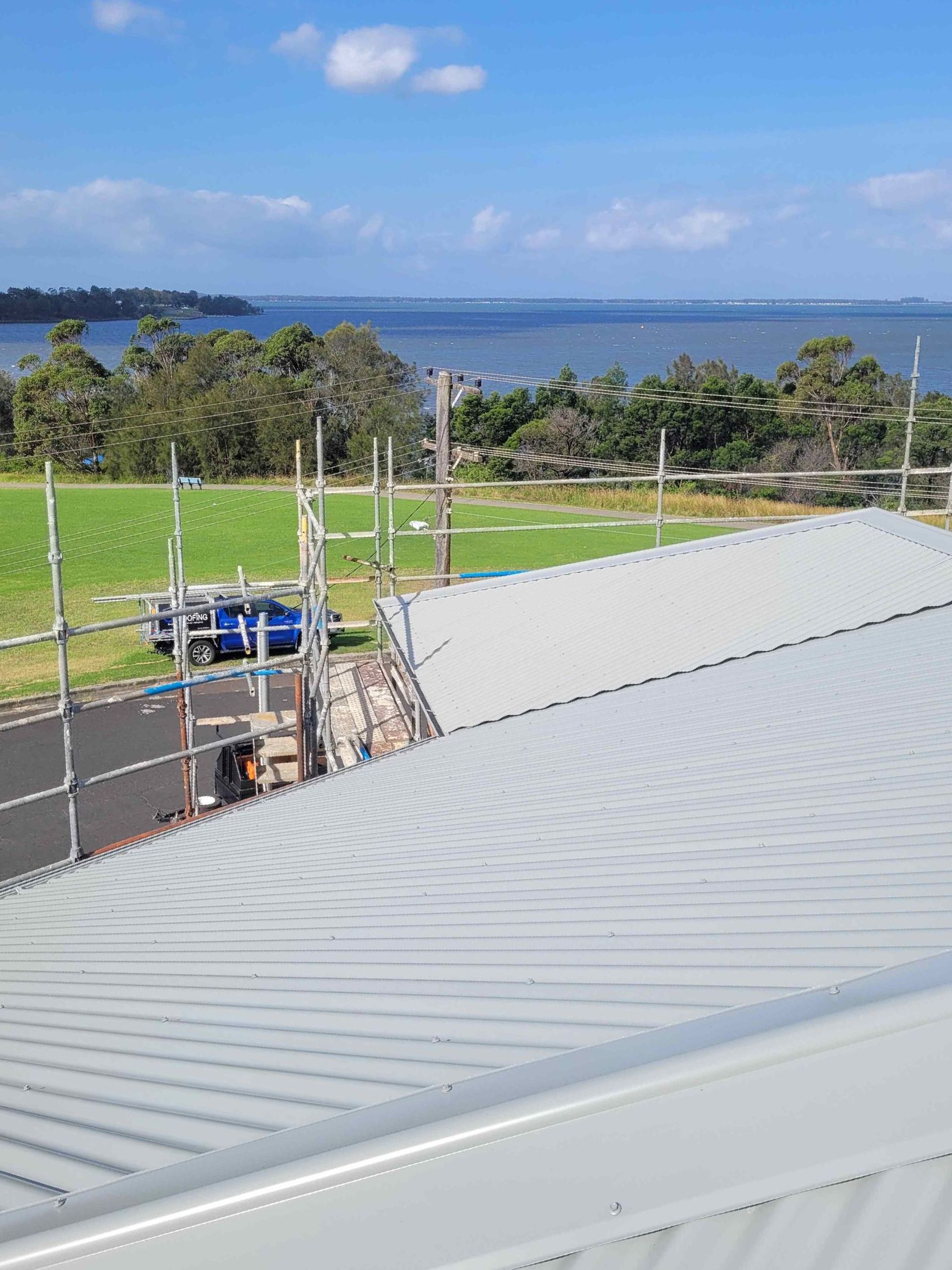 The Roof of a Building With a View of a Body of Water — GT Metal Roofing Solutions in Shoalhaven, NSW