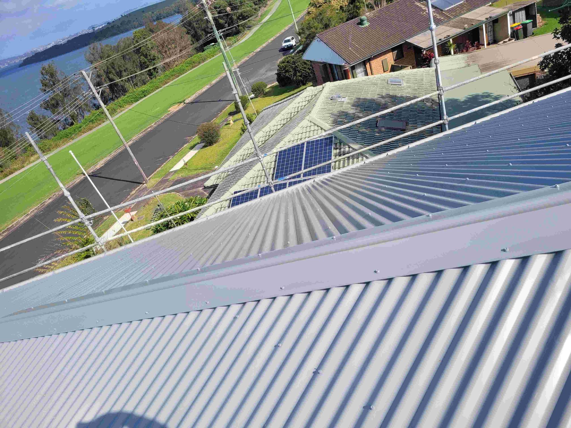 The Roof of a Building With a View of a Body of Water — GT Metal Roofing Solutions in Wollongong, NSW