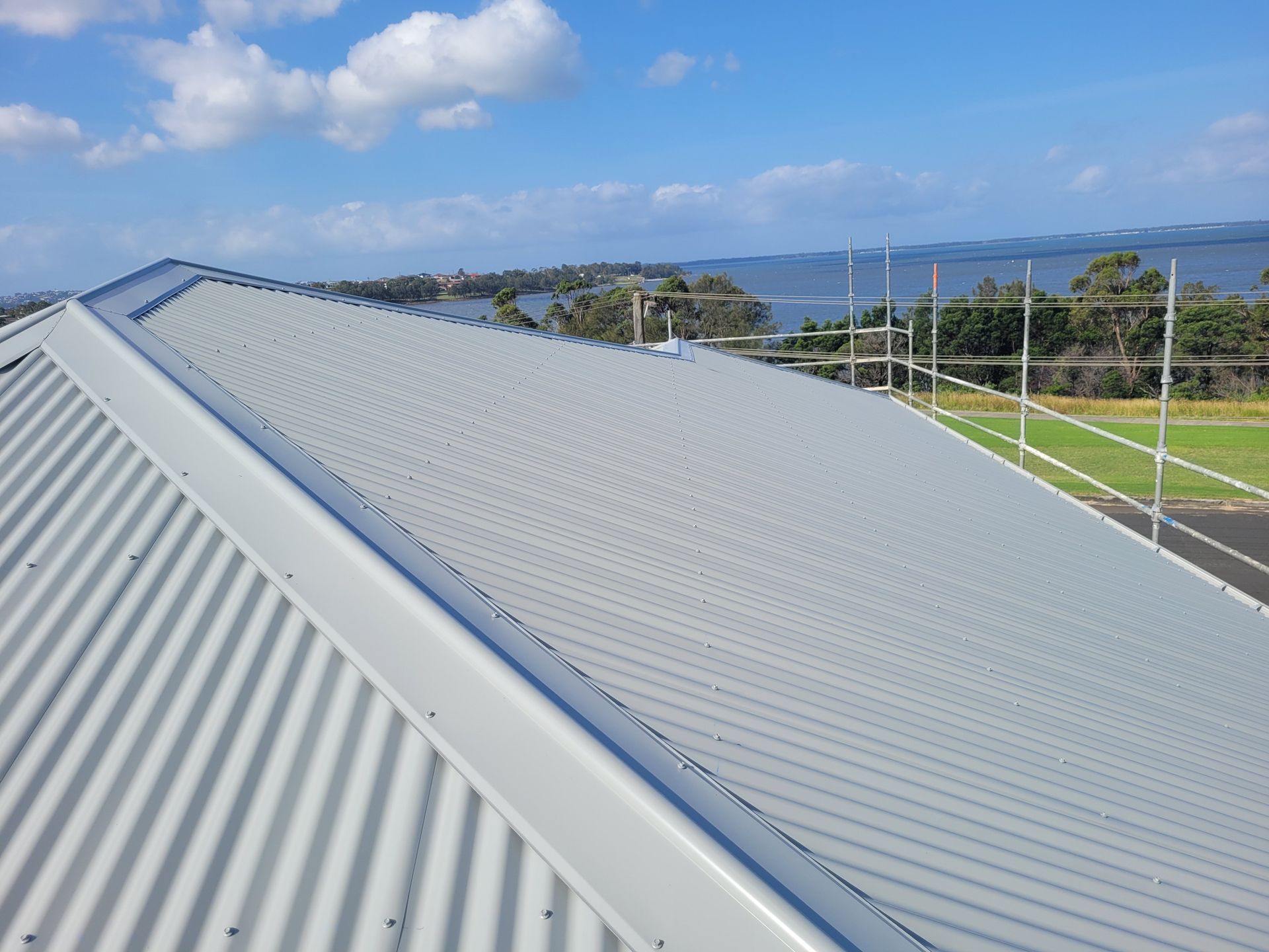A White Corrugated Metal Roof With a View of a Body of Water — GT Metal Roofing Solutions in Corrimal, NSW 