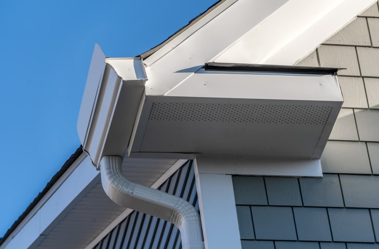 A Gutter on the Side of a House With a Blue Sky in the Background — GT Metal Roofing Solutions in Corrimal, NSW