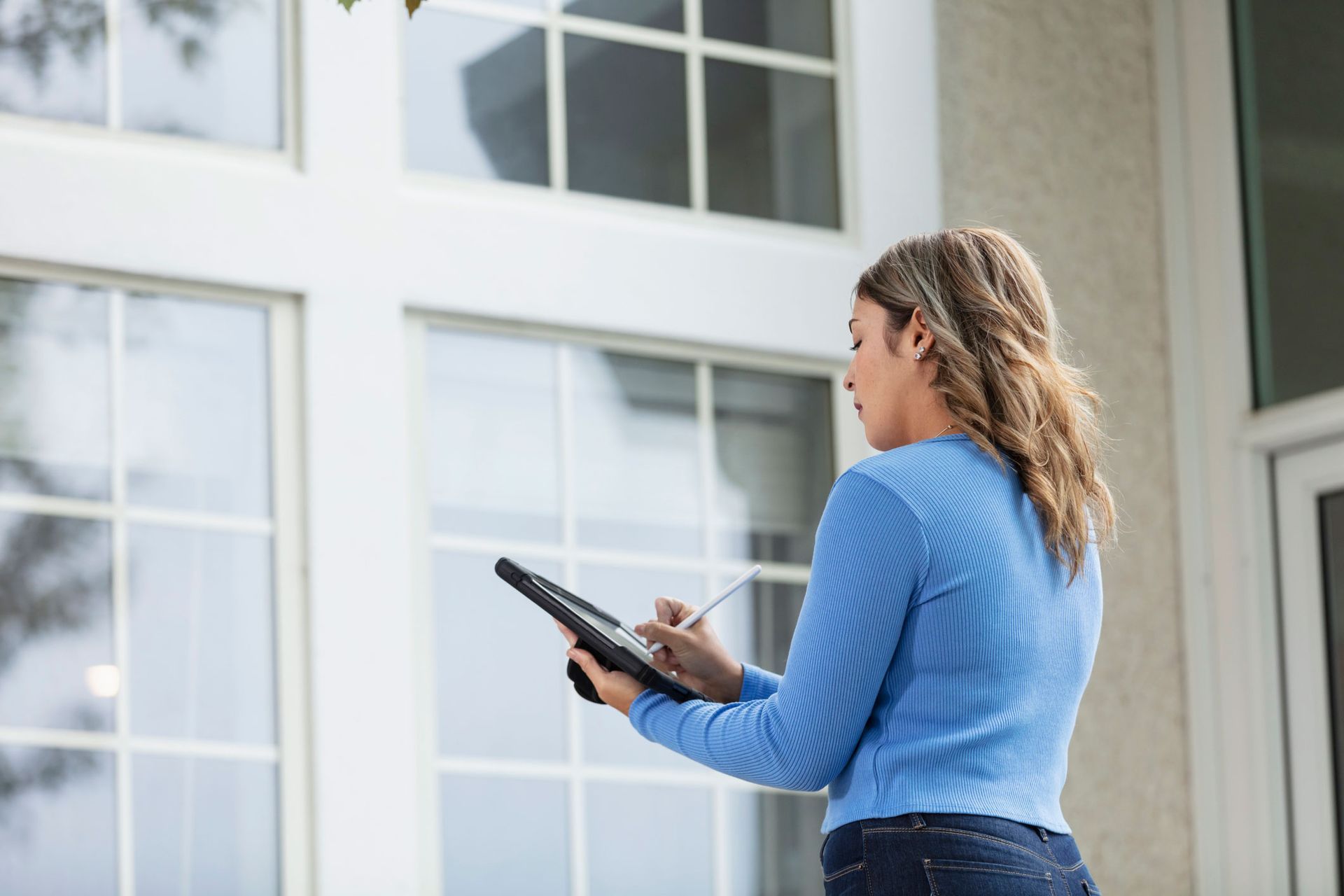 Woman Using A Tablet — Austin, TX — Rockstar Home Evaluation LLC