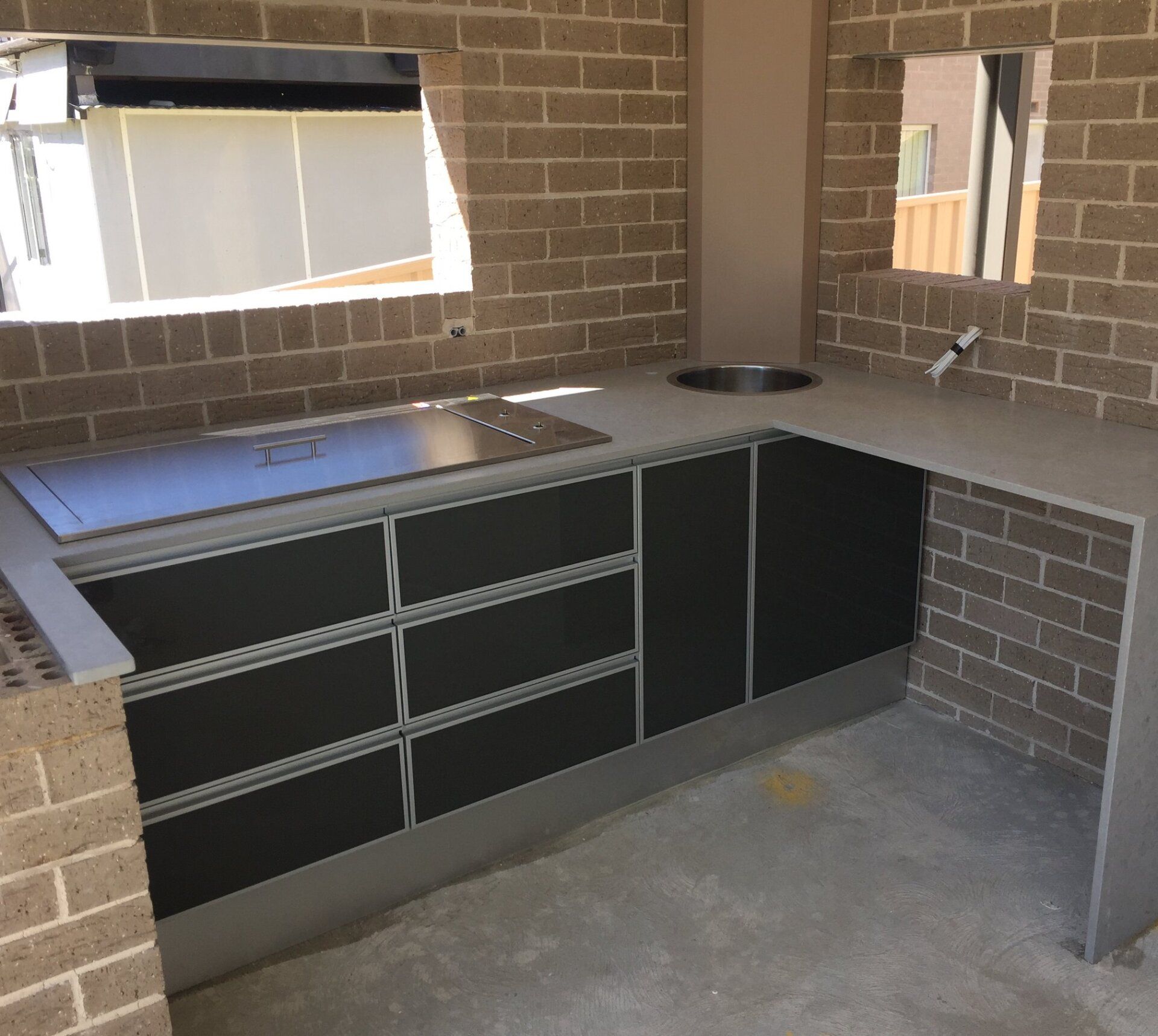 Outdoor Kitchen Black Cabinets — Kitchen Design Experts in Central Coast, NSW