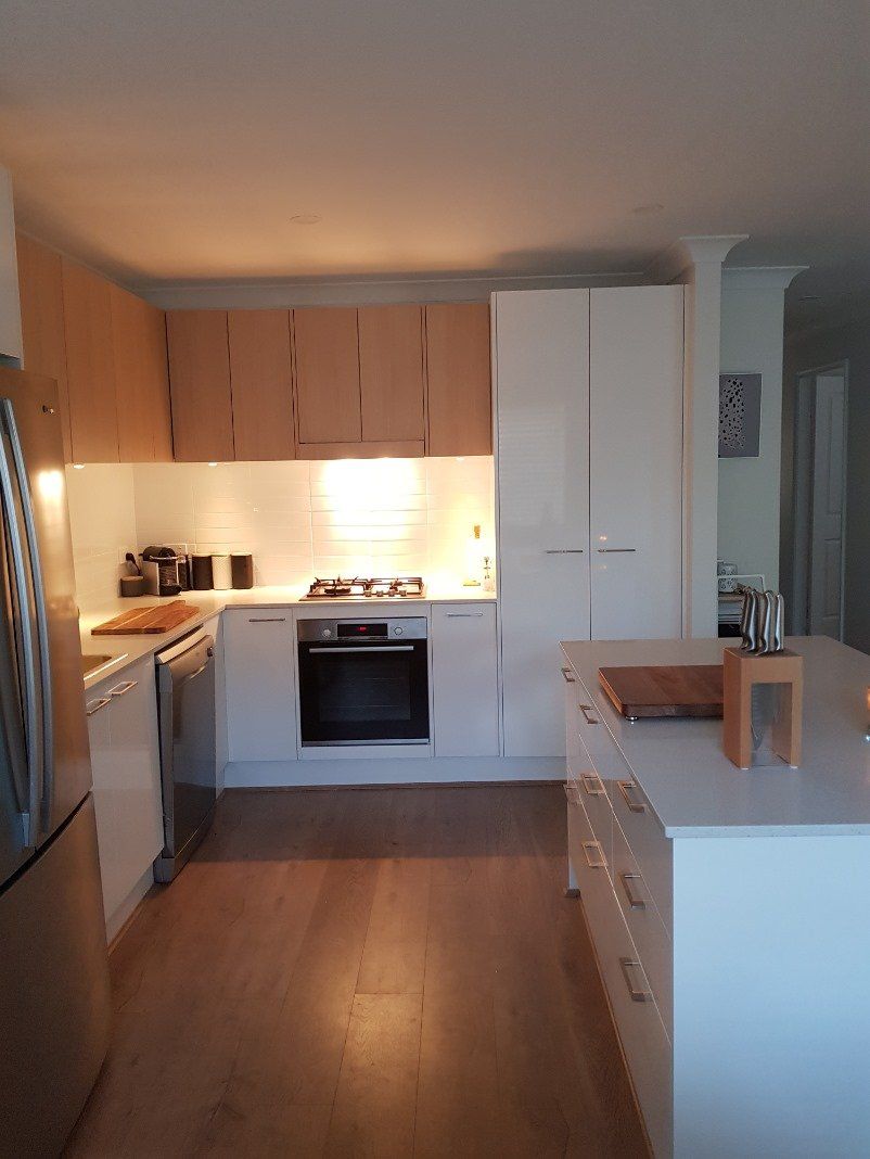 Beautiful Kitchen With White And Wooden Cabinets — Kitchen Design Experts in Central Coast, NSW