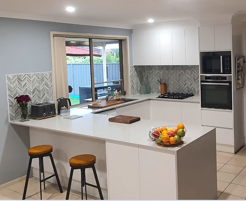 Kitchen With White Furniture And Bar Stools — Kitchen Design Experts in Central Coast, NSW