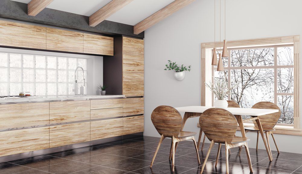 Modern Kitchen With Wooden Chairs And Table — Kitchen Design Experts in Central Coast, NSW