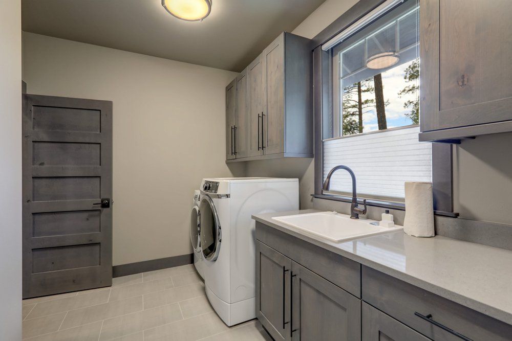 Beautiful Laundry Room With Wooden Grey Cabinets — Kitchen Design Experts in Central Coast, NSW