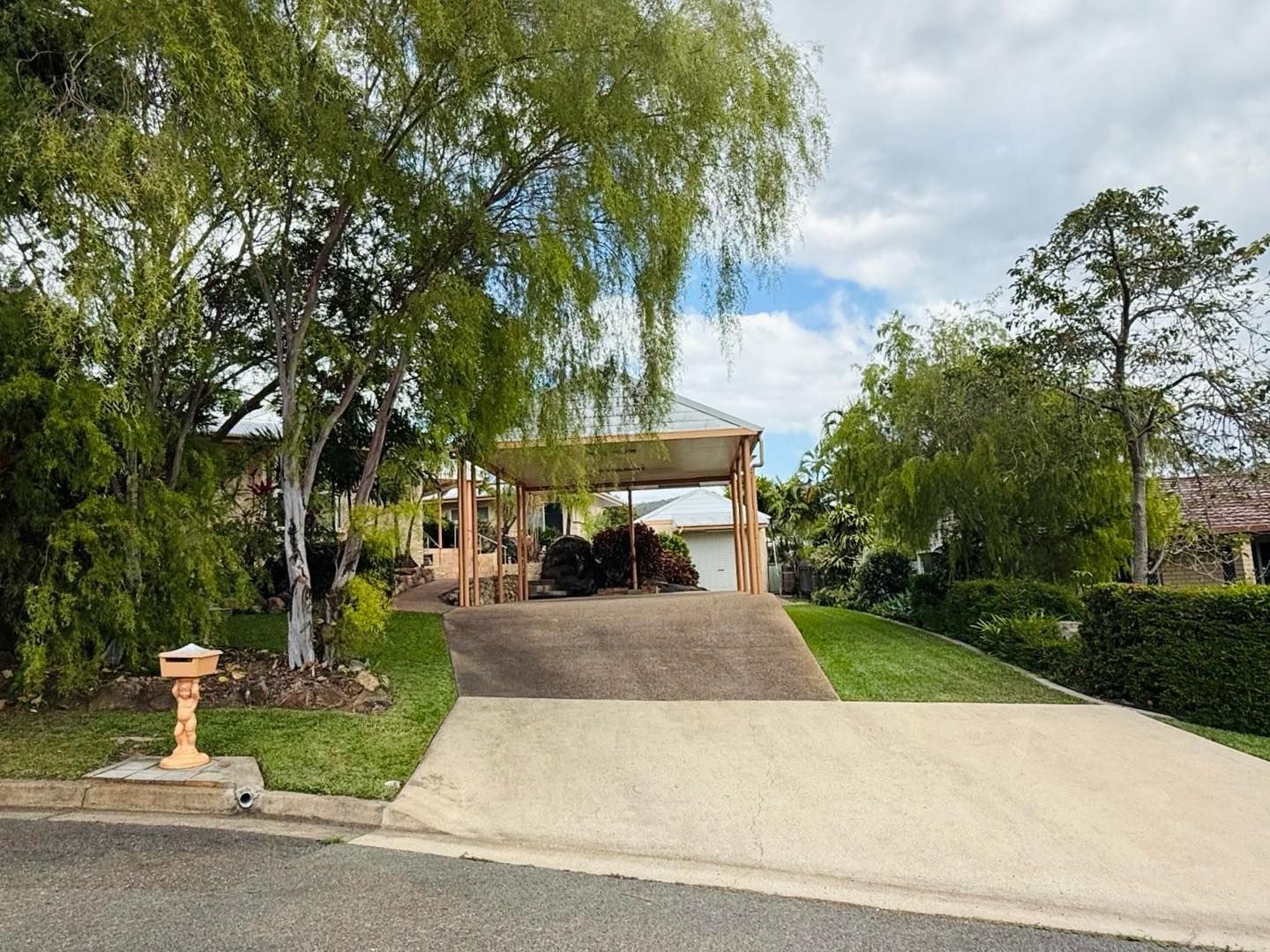 House With Covered Carport, Driveway, and Green Lawn — Hanta Mowing Services Townsville in Kirwan, QLD