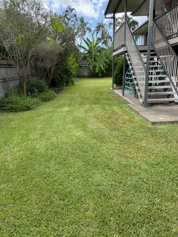 Green Lawn With Stairs Leading Up to a Two-story Building — Hanta Mowing Services Townsville in Kirwan, QLD