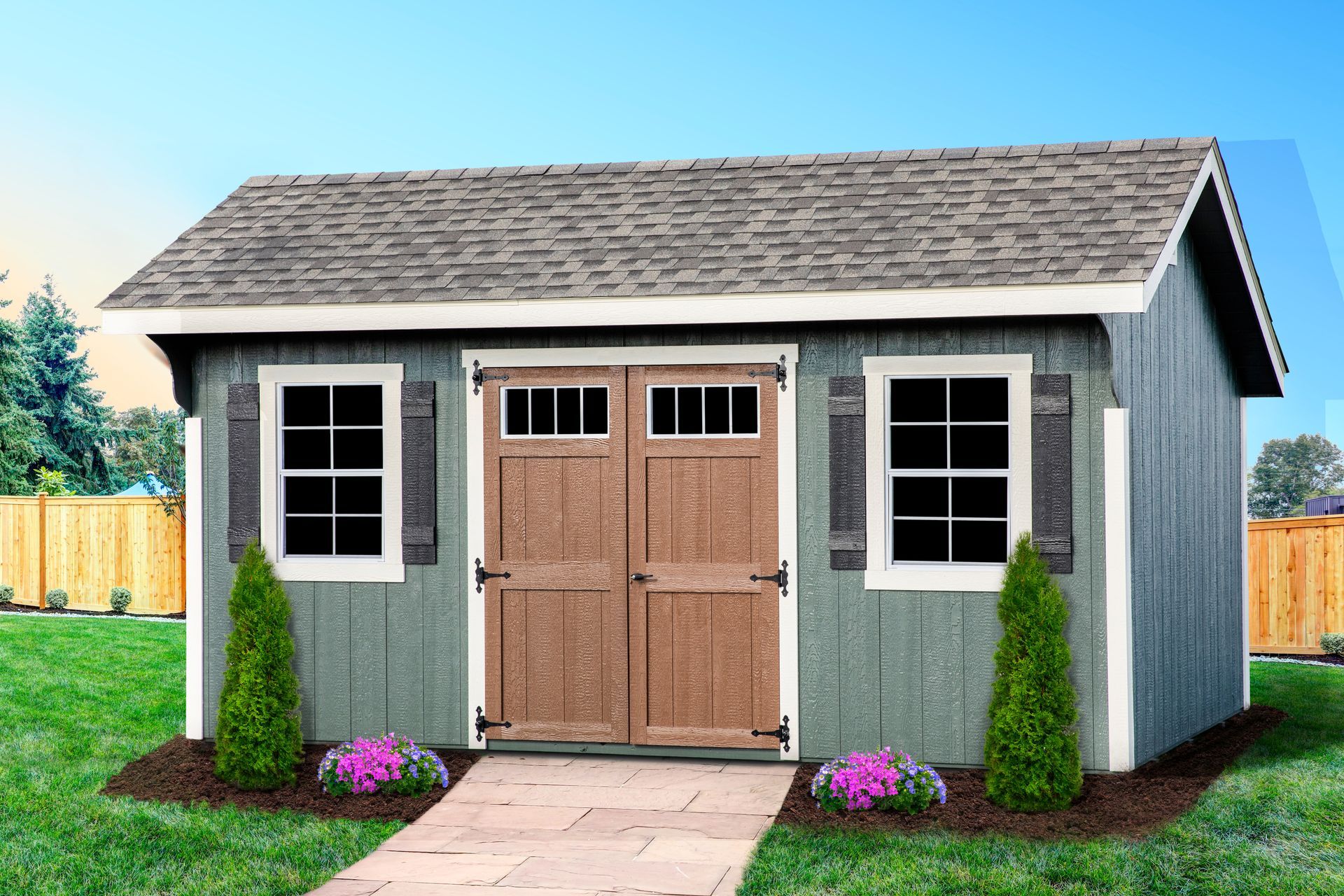 classic gray shed A small shed with a wooden door and windows is sitting in the middle of a lush green yard.