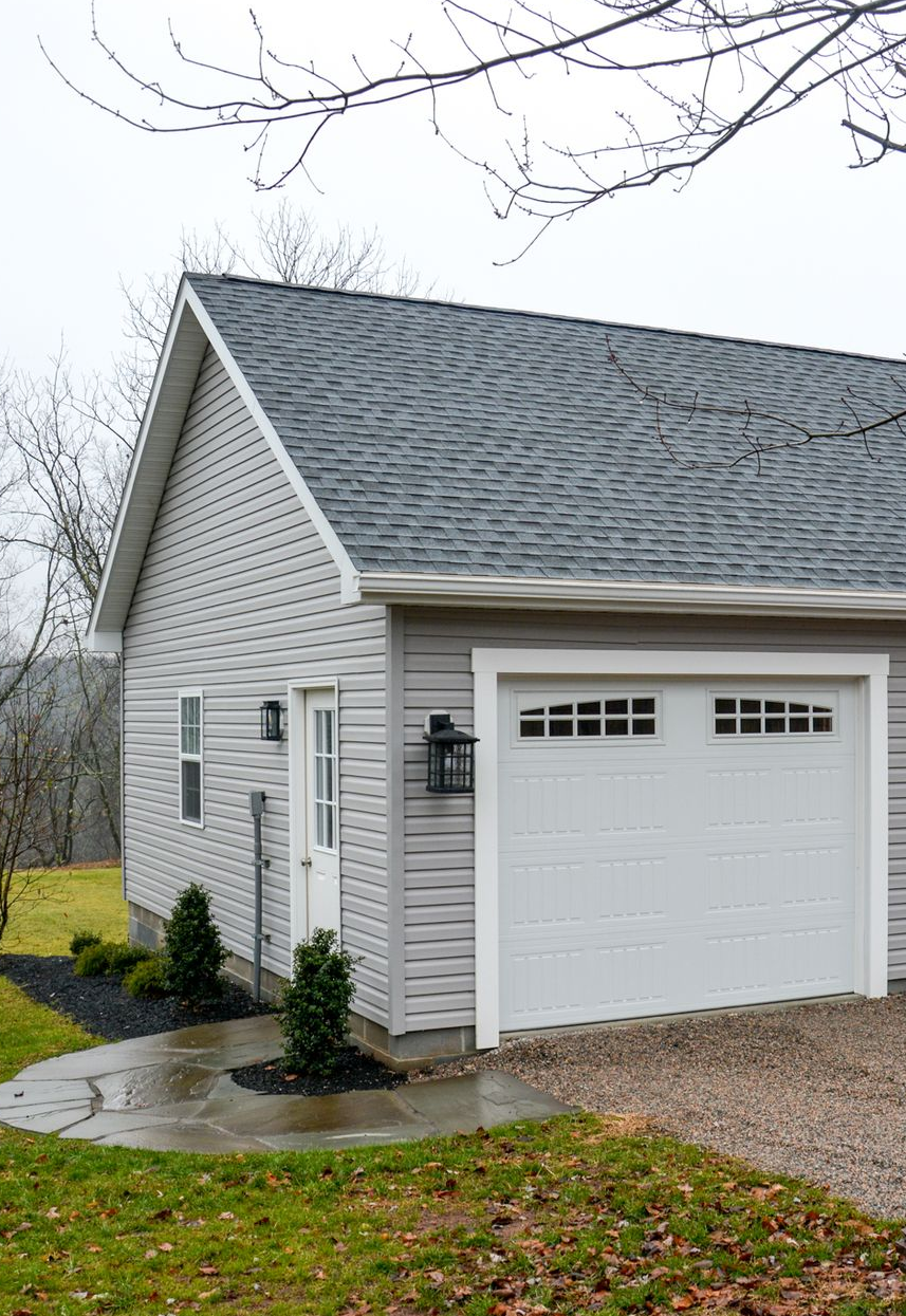 gray shed An Amish-built garage with a copper cupola on top of it