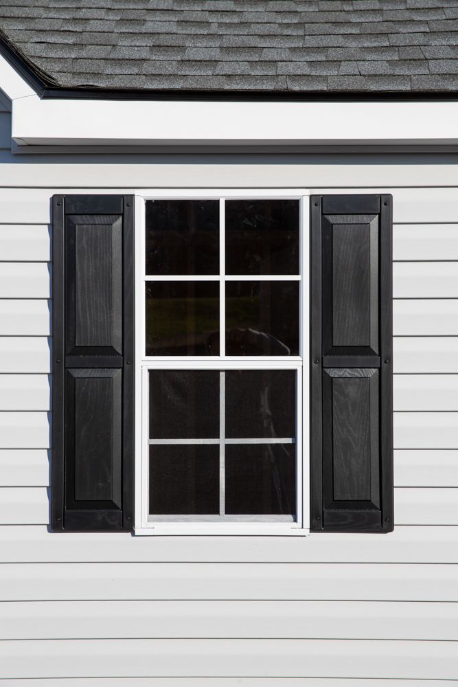 A black window on white garage siding