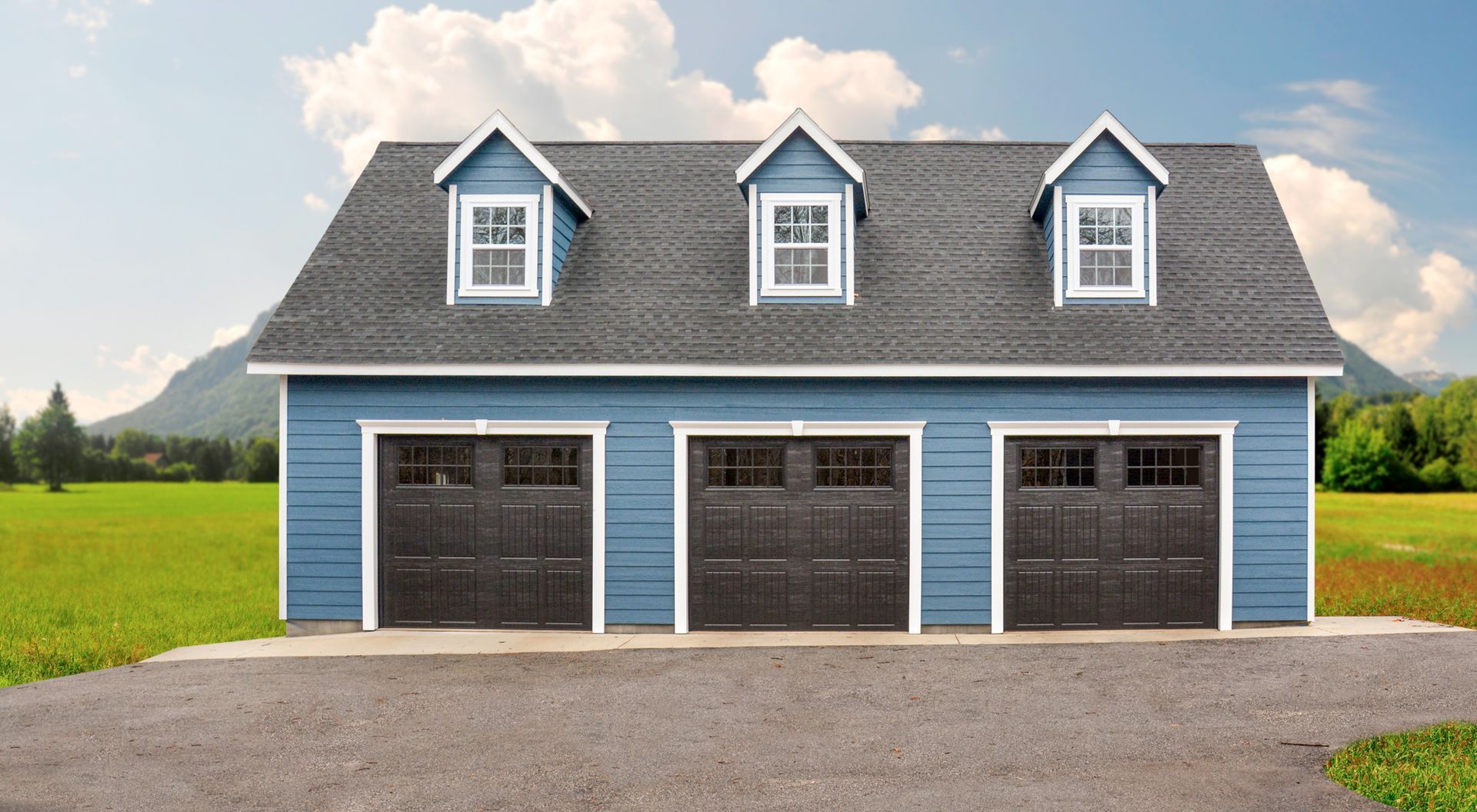 A blue three-car garage from Prestige Buildings, with blue siding, black bay doors, and white windows on a gray roof.
