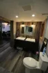 A bathroom with two sinks and a toilet.