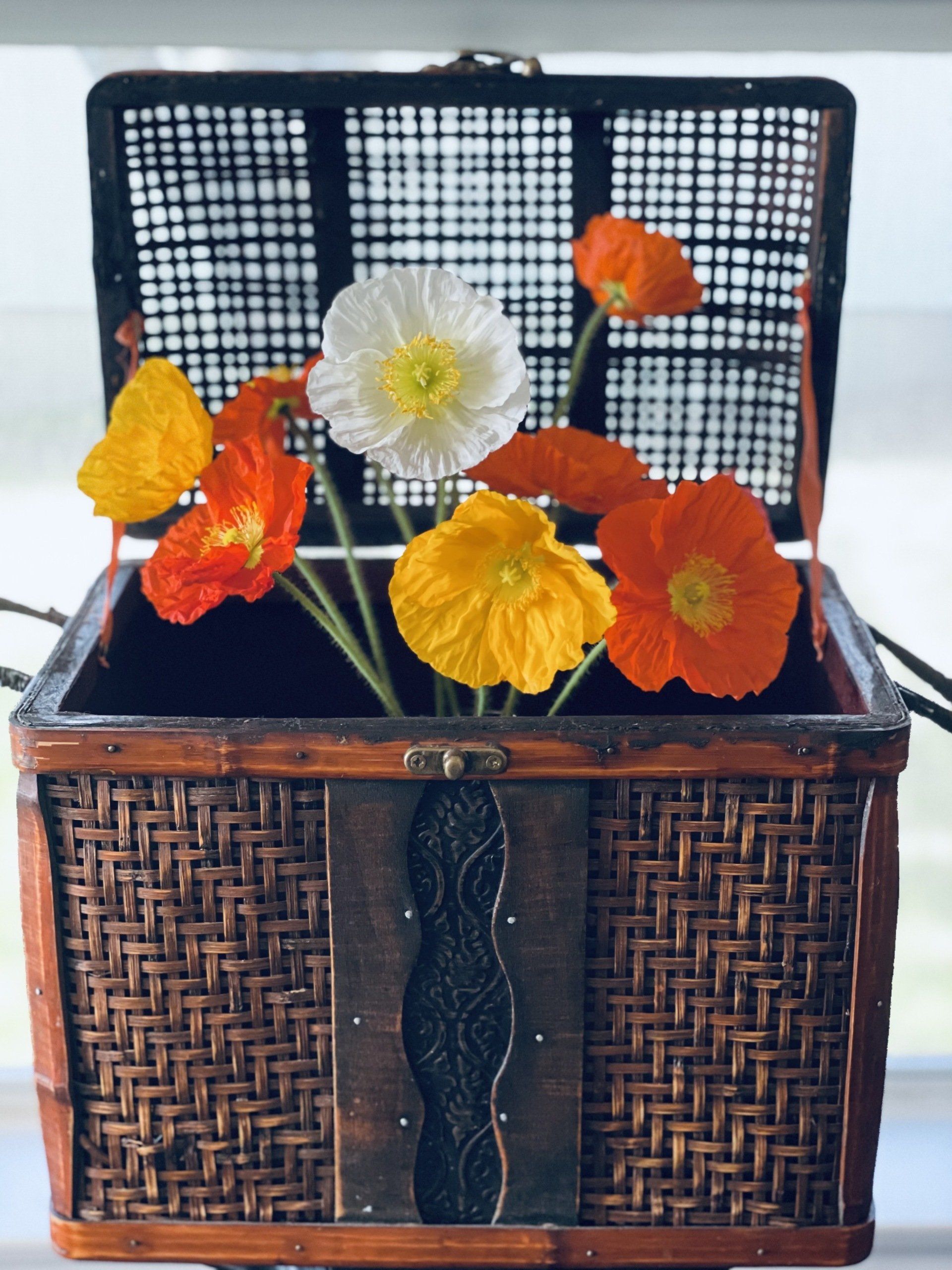 A basket filled with yellow and orange flowers