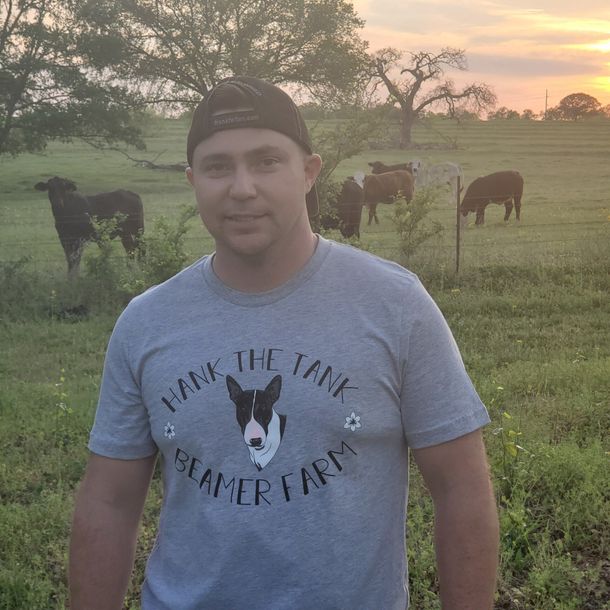 A man wearing a shirt that says hank the tank
