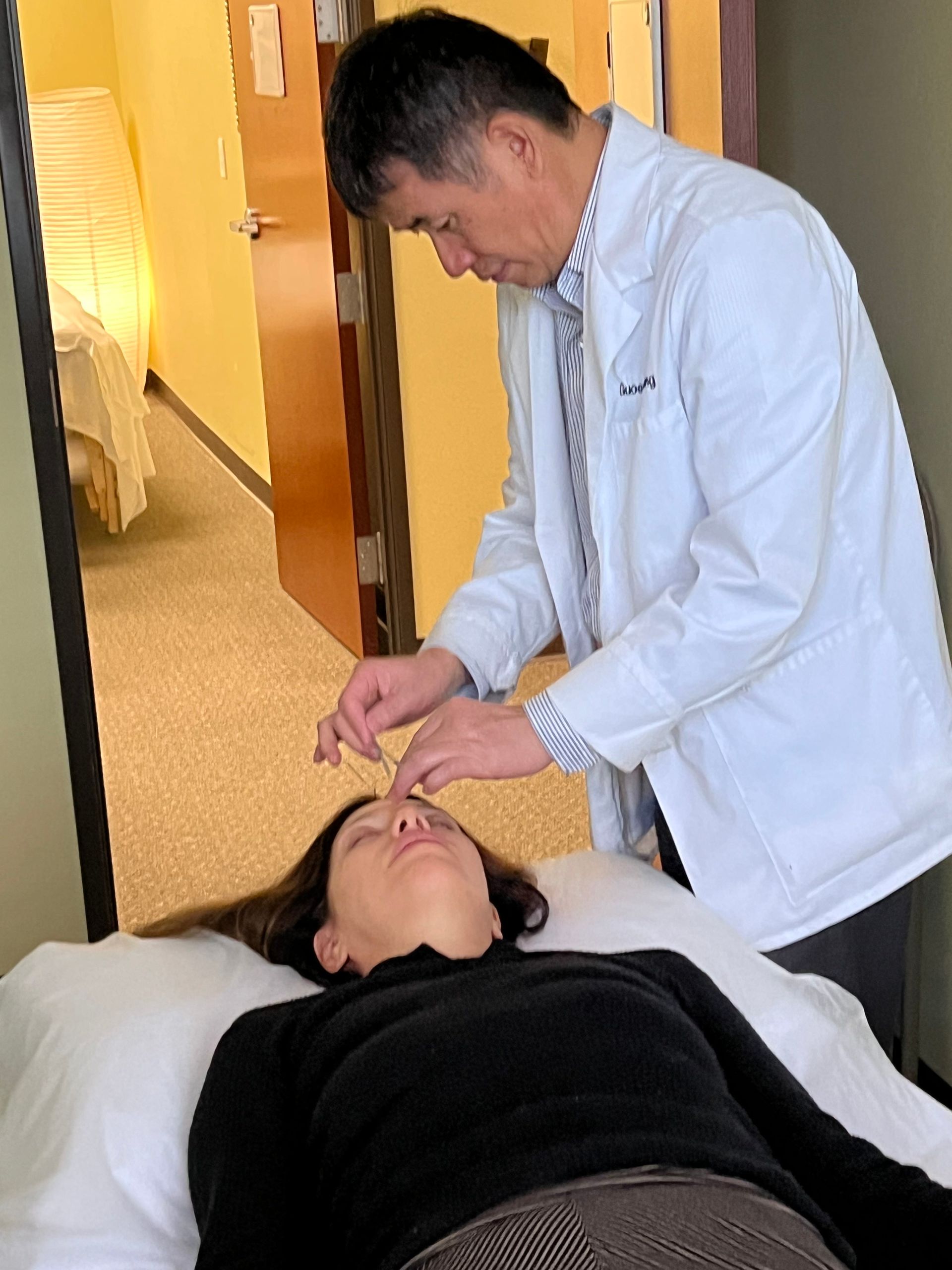 Female Receiving Acupuncture Female Receiving Acupuncture