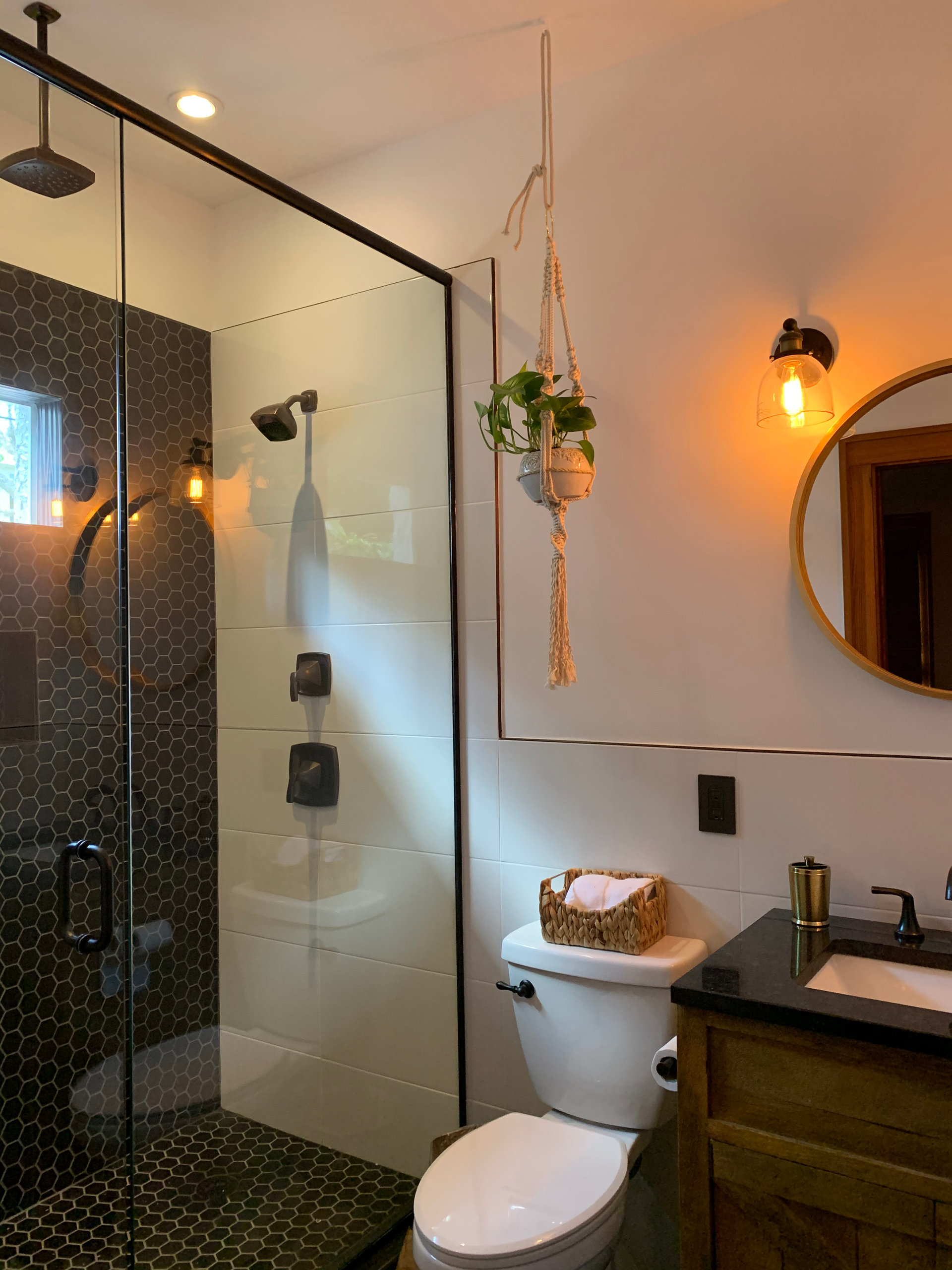 A bathroom with a toilet a sink and a mirror
