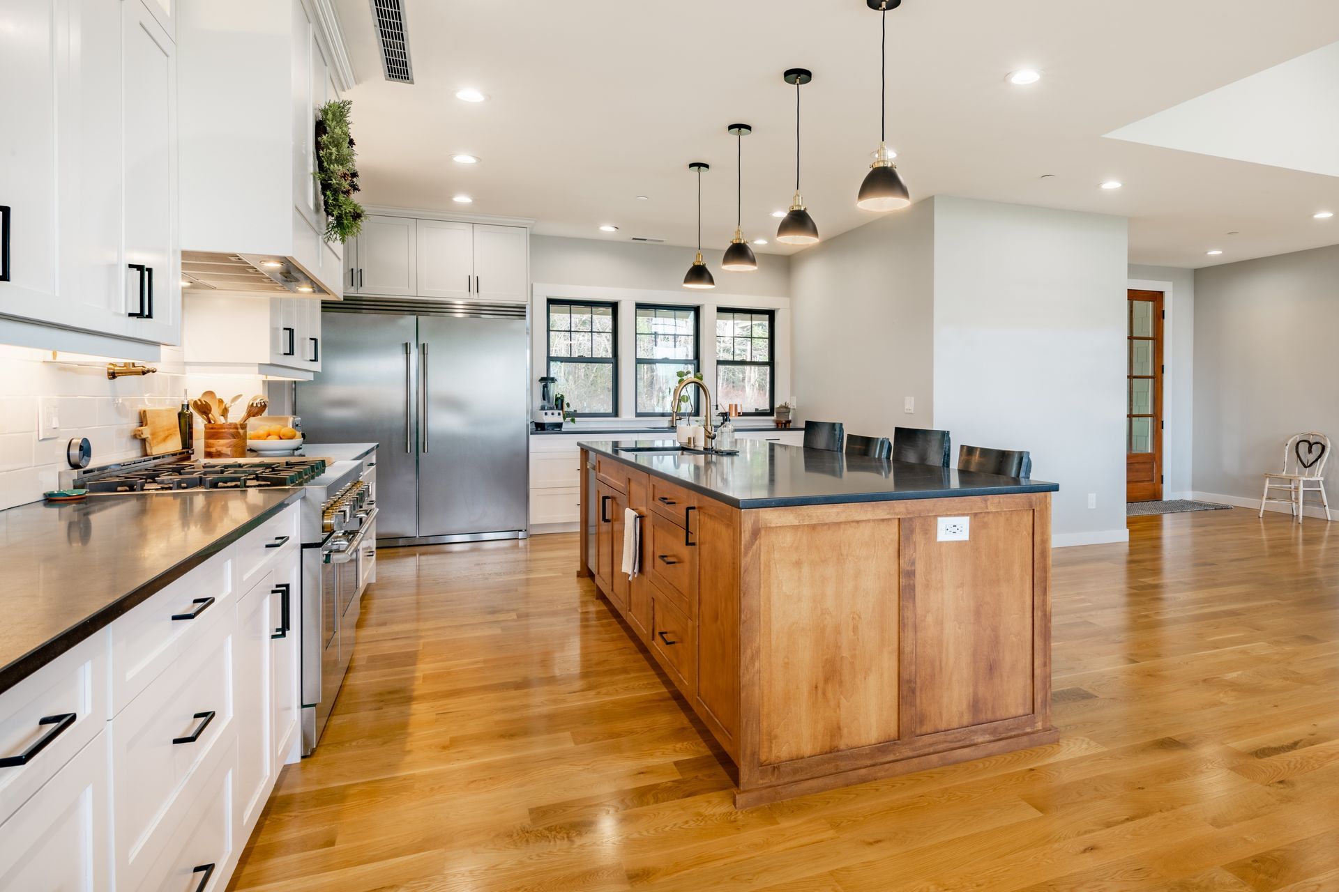 A large kitchen with stainless steel appliances and wooden cabinets.
