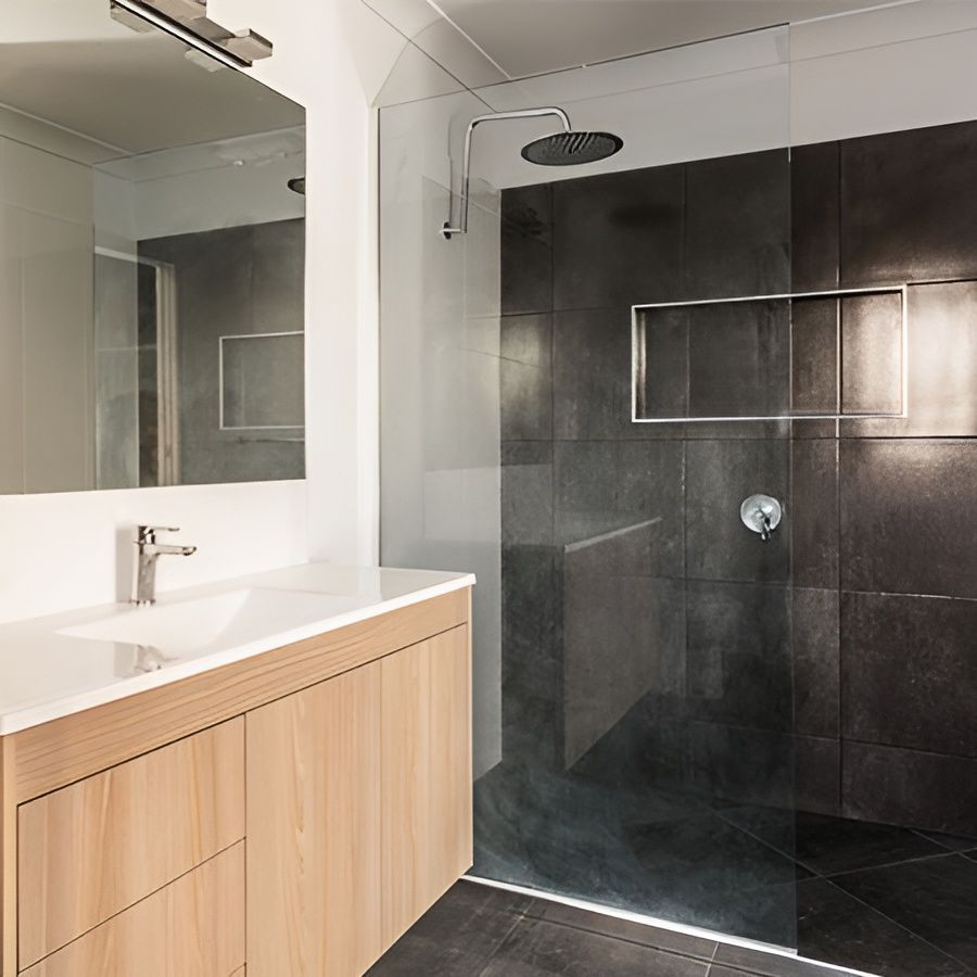 A Bathroom With a Sink and a Walk in Shower — Mackay Cabinetmaking Service In Glenella, QLD