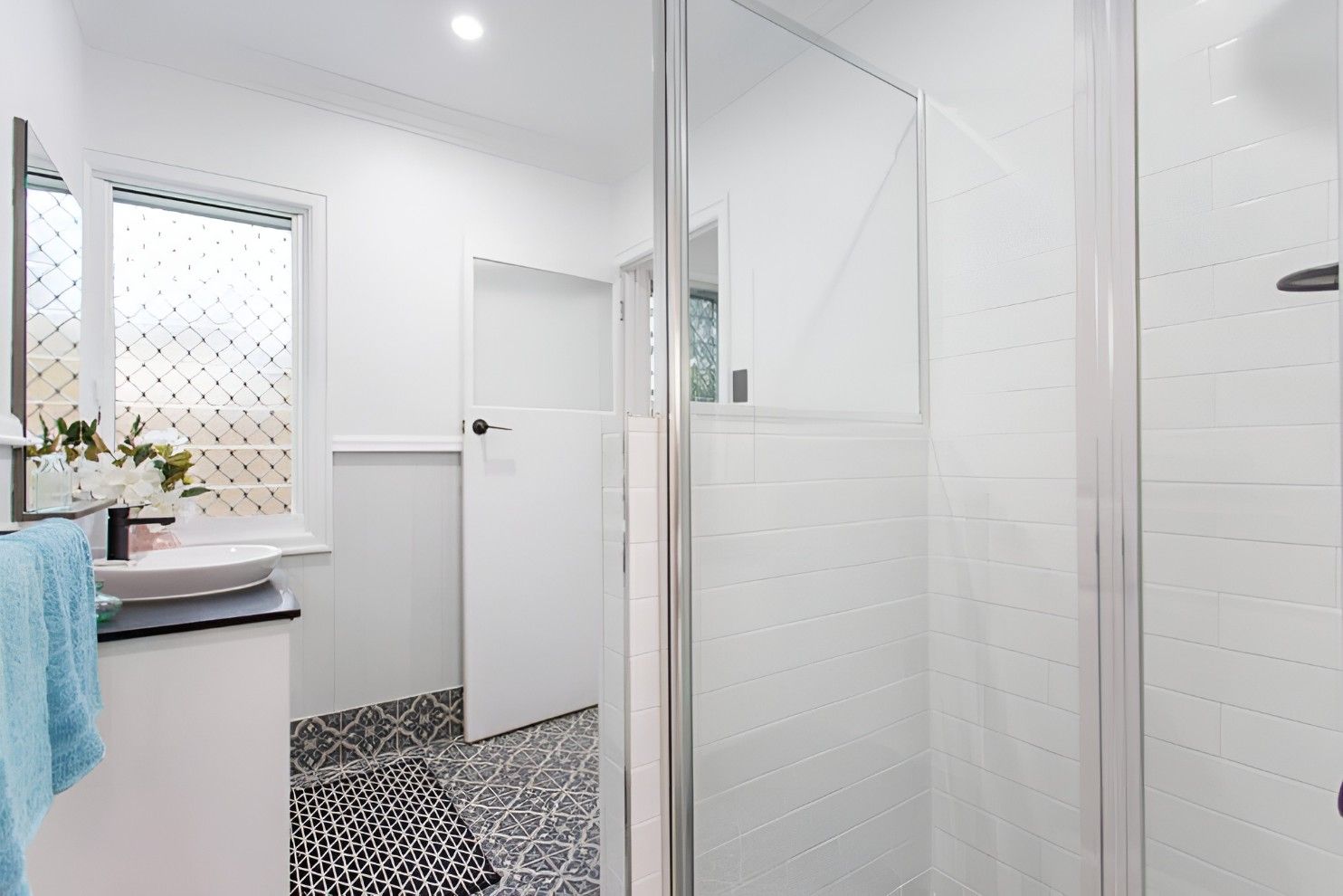 A Bathroom With a Sink and a Walk in Shower — Mackay Cabinetmaking Service In Glenella, QLD