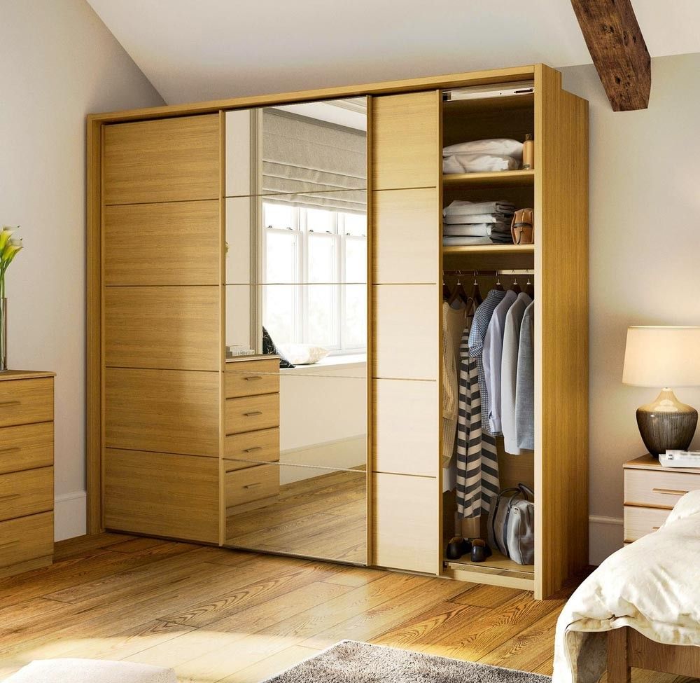 A Bedroom With a Large Wooden Wardrobe With Sliding Doors — Mackay Cabinetmaking Service In Glenella, QLD