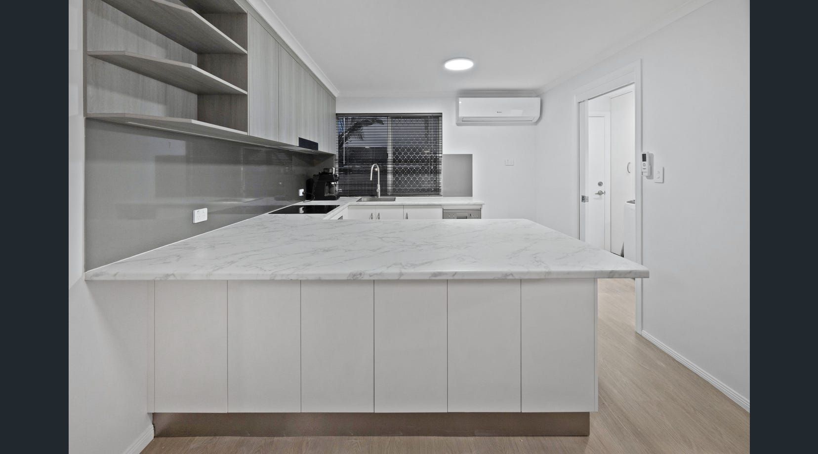 Bright modern kitchen with white cabinets — Mackay Cabinetmaking Service In Glenella, QLD