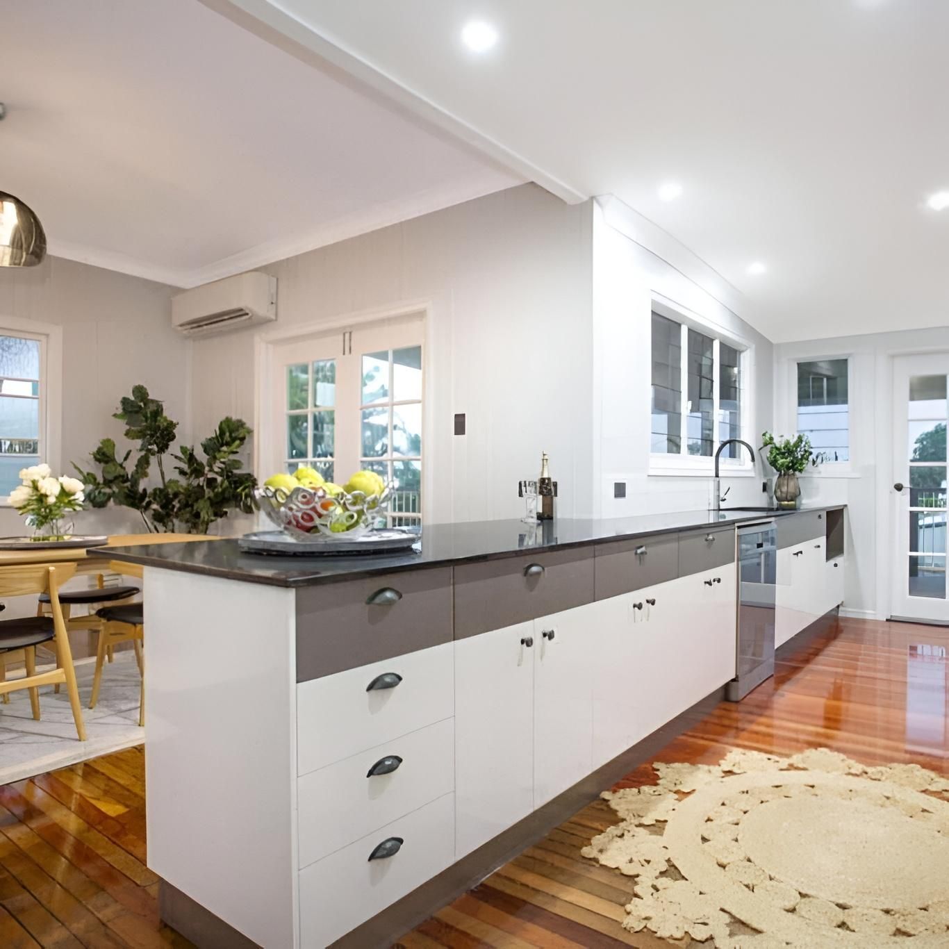 Bright modern kitchen with white cabinets — Mackay Cabinetmaking Service In Glenella, QLD