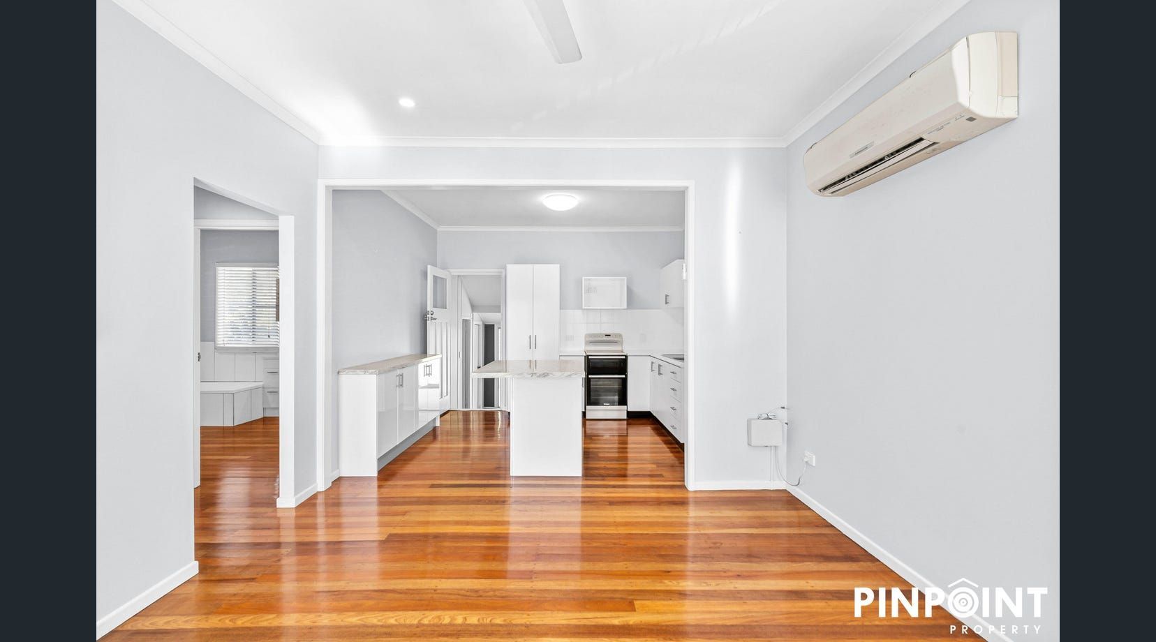Bright empty apartment interior with polished wood floors — Mackay Cabinetmaking Service In Glenella, QLD