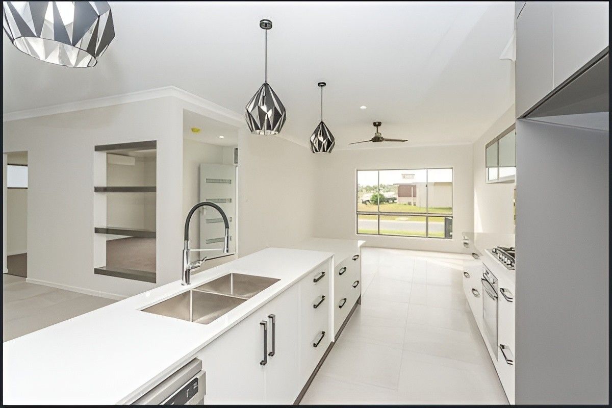 A Kitchen With White Cabinets and Stainless Steel Appliances — Mackay Cabinetmaking Service In Sarina, QLD