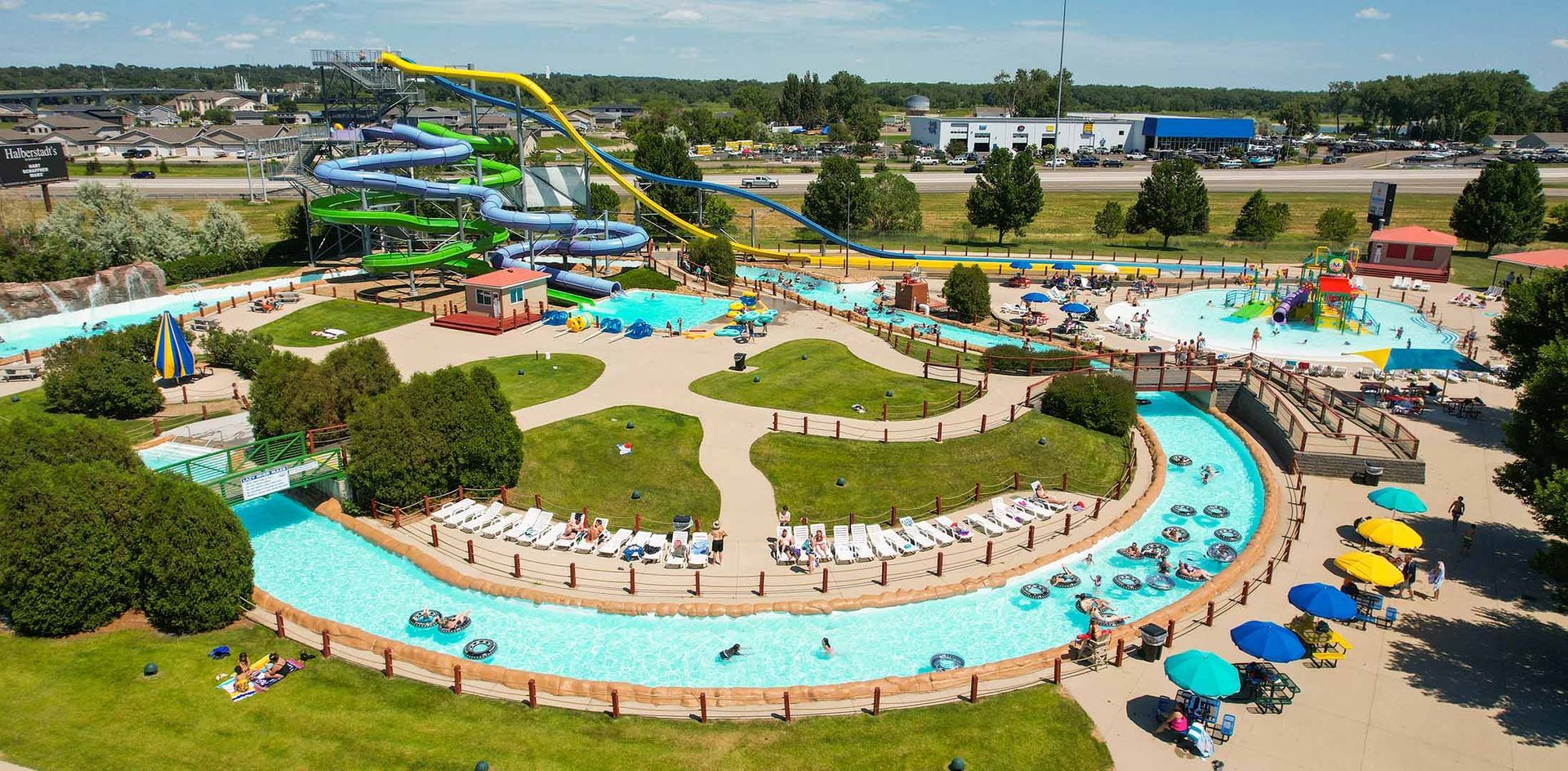 An aerial view of a water park with a river and a water slide.