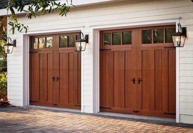 Close-up of wood carriage garage doors with black hardware