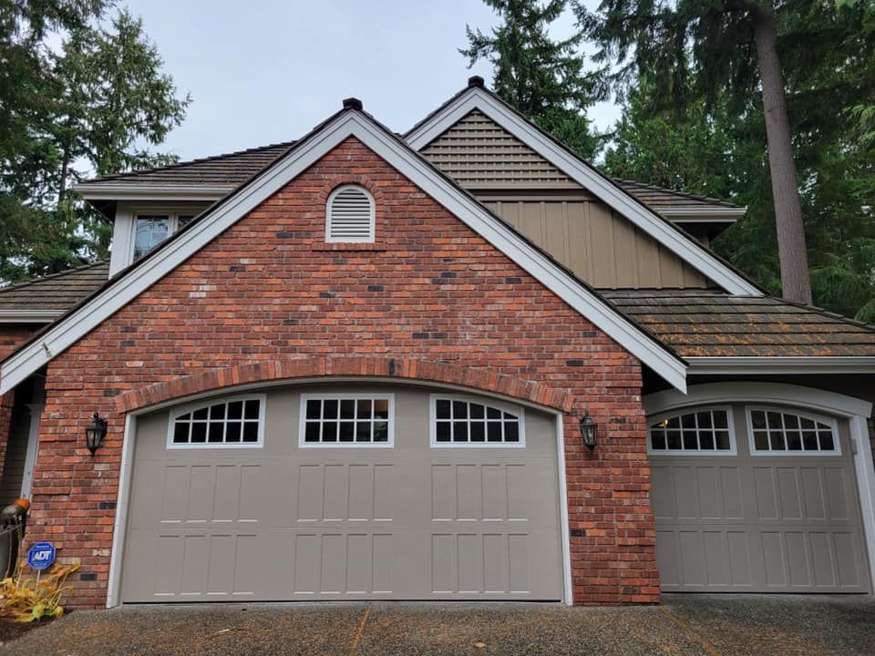 Brick home with a new steel carriage house garage door