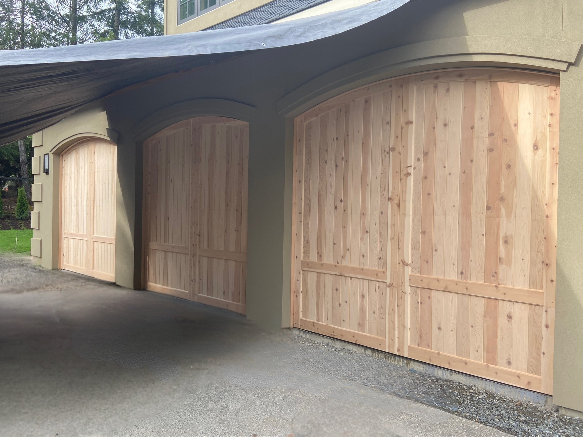 Close-up of unfinished natural wood carriage garage doors